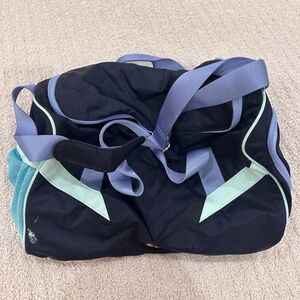 Black and purple duffel bag with mesh pockets and zippered pocket